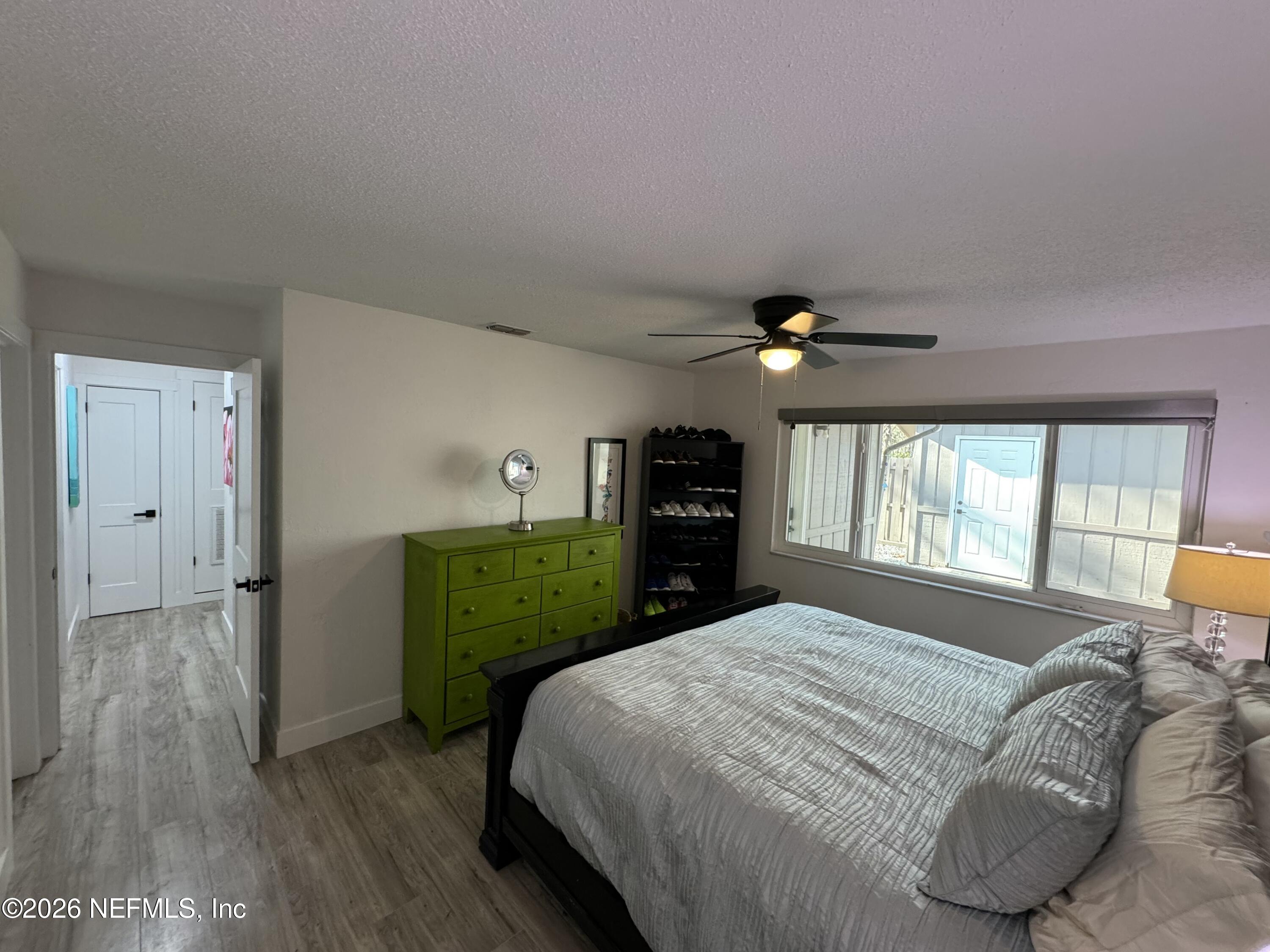 49 Cypress Pond Road Port Orange, FL 32128 - Photo 10 of 16 a bedroom with a bed and a chandelier