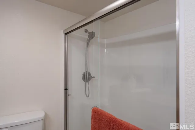 a bathroom with a shower and a toilet