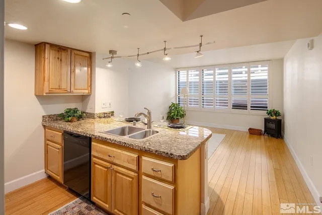 a spacious bathroom with a granite countertop sink and a bathtub