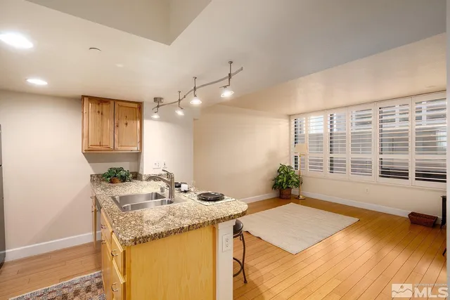 a bathroom with a granite countertop sink and a large mirror