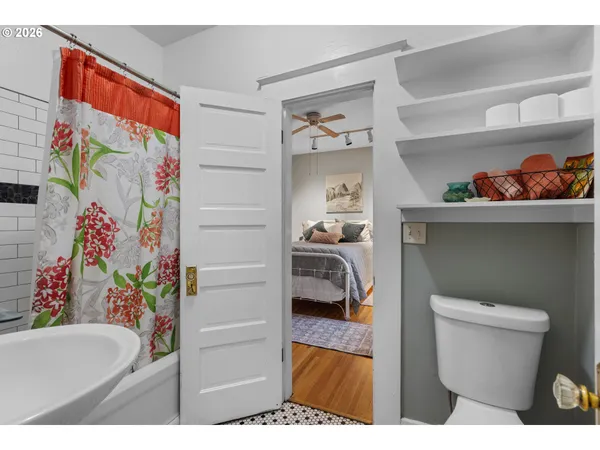 a bathroom with a toilet and a shower curtain