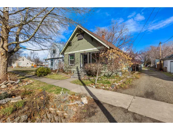 a view of a yard with wooden fence