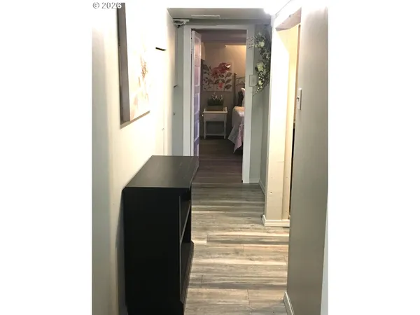 a view of a hallway with wooden floor