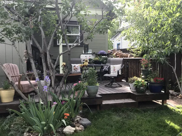 a view of a chair and table in backyard