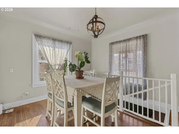 a view of a dining room with furniture and chandelier