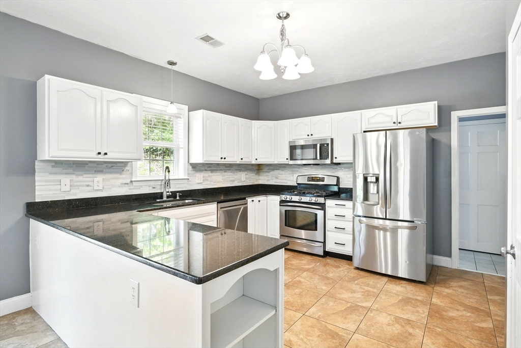 28 Ayers Road Monson, MA 01057 - Photo 15 of 42 a kitchen with kitchen island granite countertop appliances cabinets and a sink