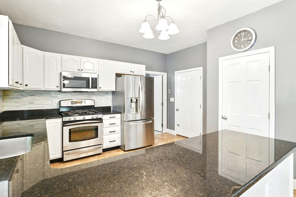 28 Ayers Road Monson, MA 01057 - Photo 16 of 42 a kitchen with stainless steel appliances granite countertop a stove a refrigerator and a sink