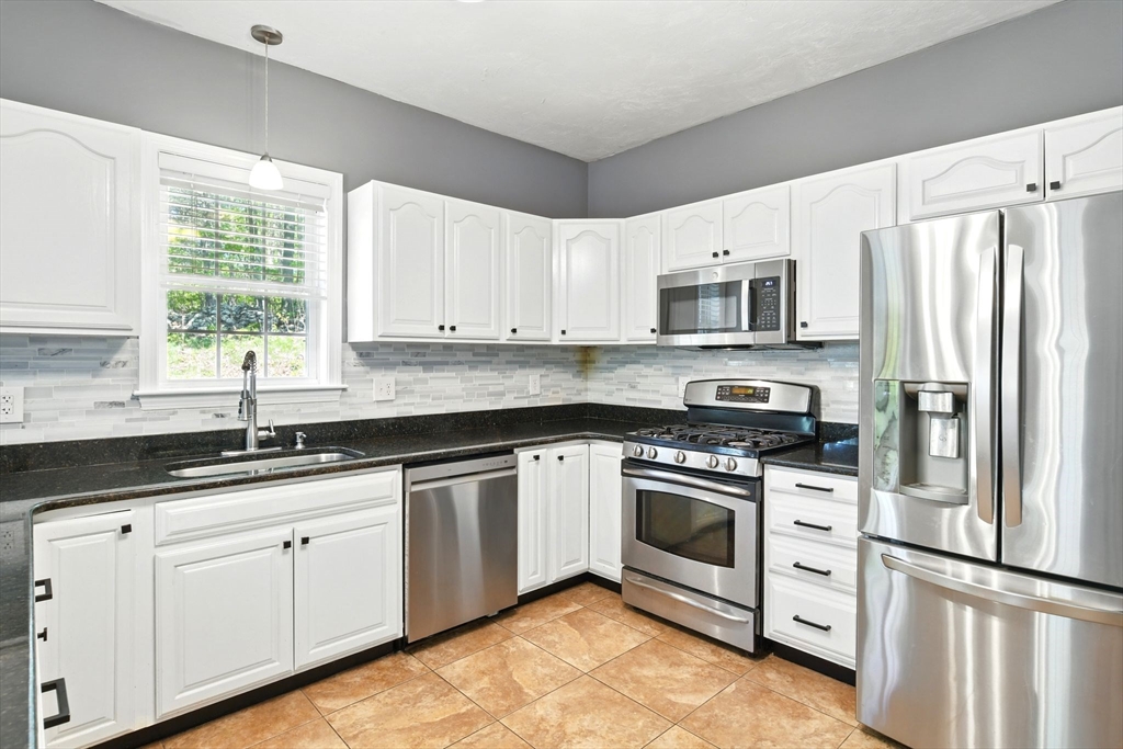 28 Ayers Road Monson, MA 01057 - Photo 17 of 42 a kitchen with granite countertop white cabinets and stainless steel appliances
