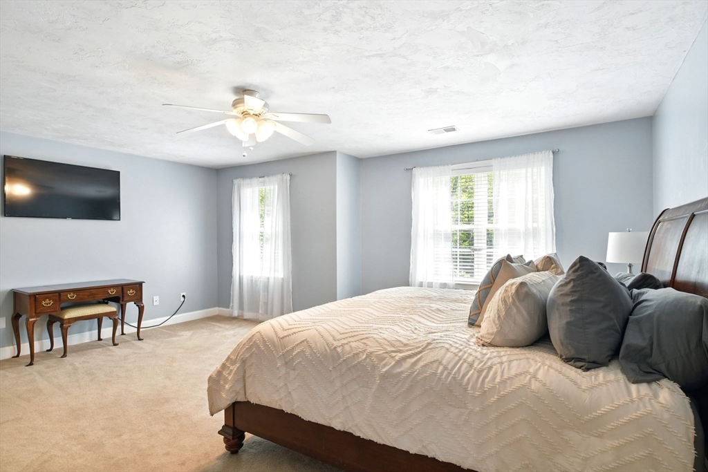28 Ayers Road Monson, MA 01057 - Photo 23 of 42 a bedroom with a bed and a chandelier