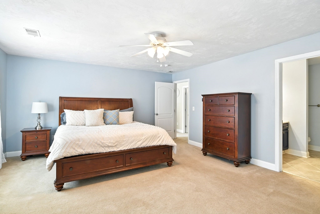 28 Ayers Road Monson, MA 01057 - Photo 25 of 42 a spacious bedroom with a bed and a chandelier