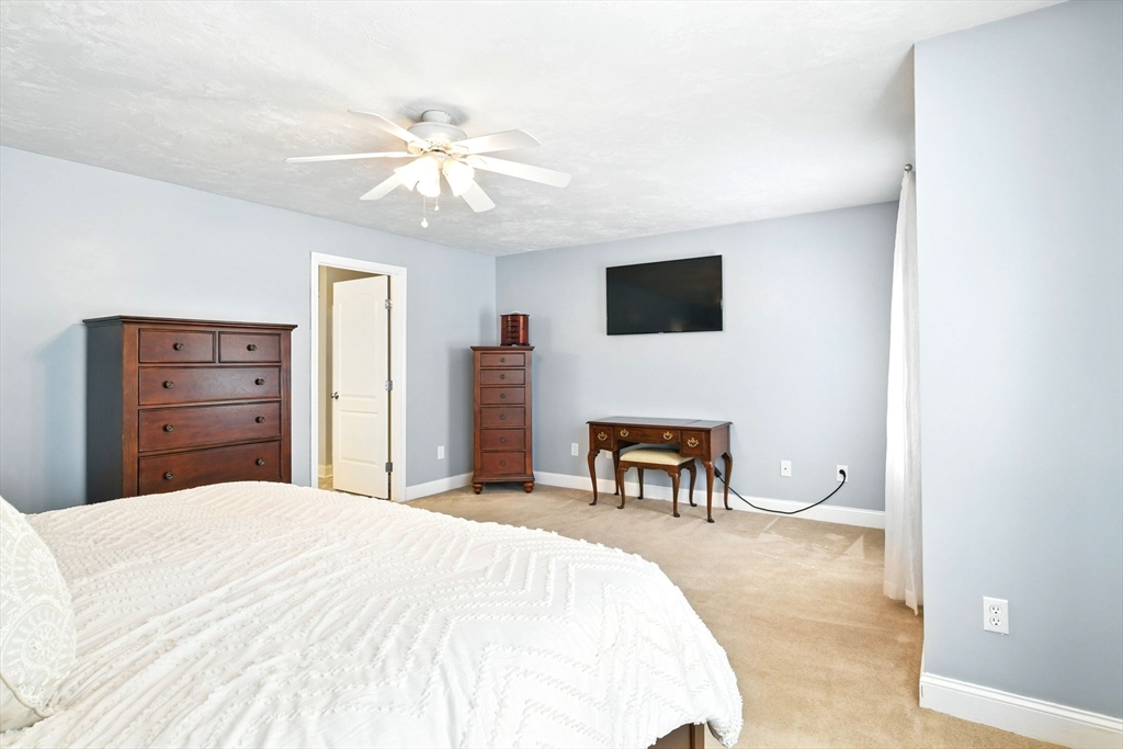28 Ayers Road Monson, MA 01057 - Photo 26 of 42 a bedroom with a bed and a chandelier