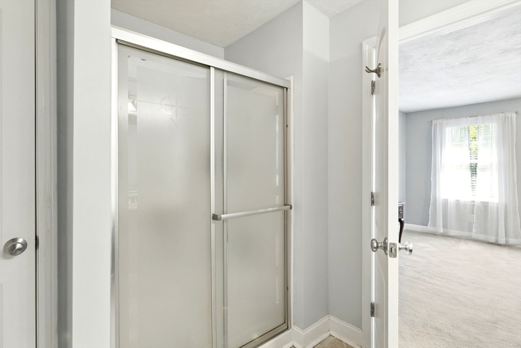 28 Ayers Road Monson, MA 01057 - Photo 28 of 42 a bathroom with a glass shower door