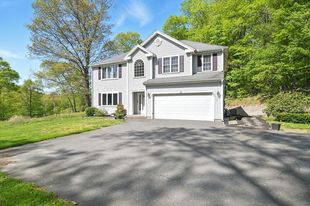 28 Ayers Road Monson, MA 01057 - Photo 3 of 42 a front view of a house with a yard and garage