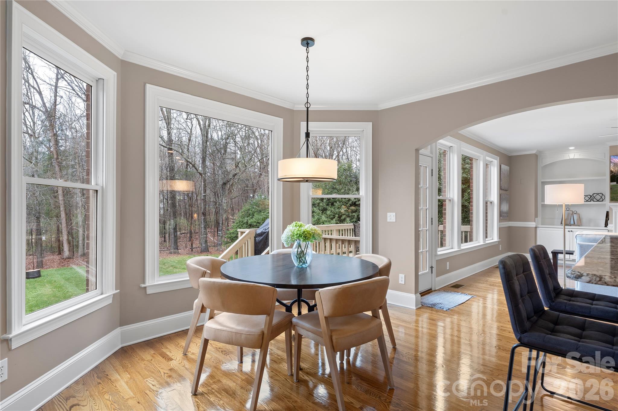 1716 Hickory Ridge Drive Waxhaw, NC 28173 - Photo 15 of 48 a dining room with furniture a chandelier and wooden floor