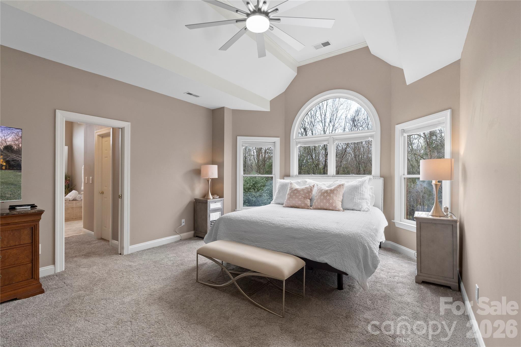 1716 Hickory Ridge Drive Waxhaw, NC 28173 - Photo 22 of 48 a bedroom with a large bed and a chandelier