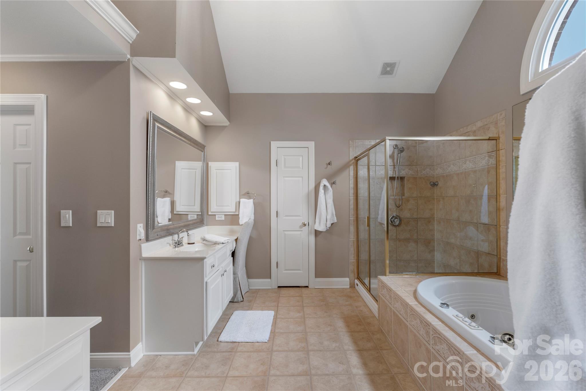 1716 Hickory Ridge Drive Waxhaw, NC 28173 - Photo 26 of 48 a spacious bathroom with a granite countertop tub shower and mirror