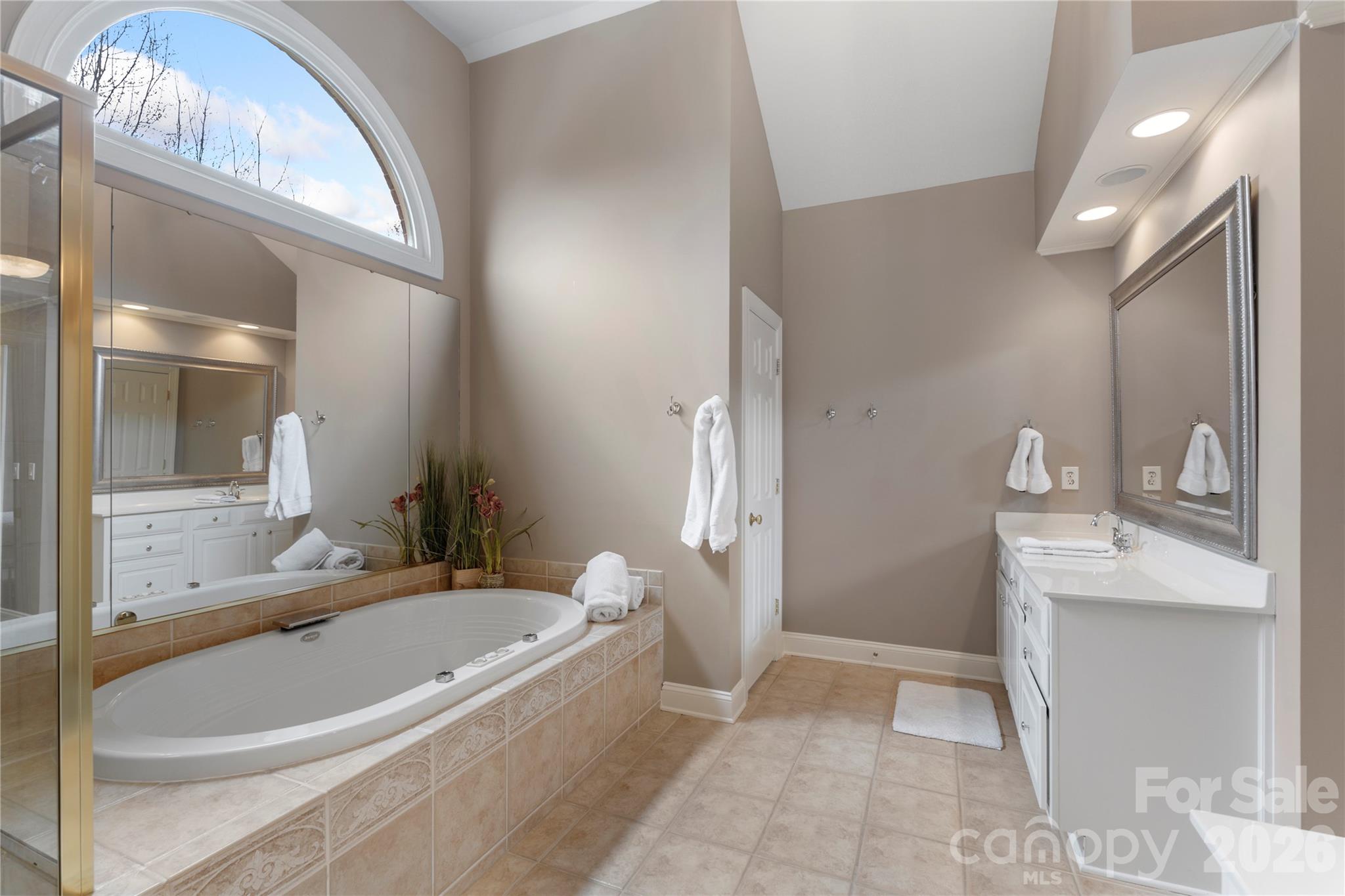 1716 Hickory Ridge Drive Waxhaw, NC 28173 - Photo 27 of 48 a bathroom with a granite countertop tub sink and mirror