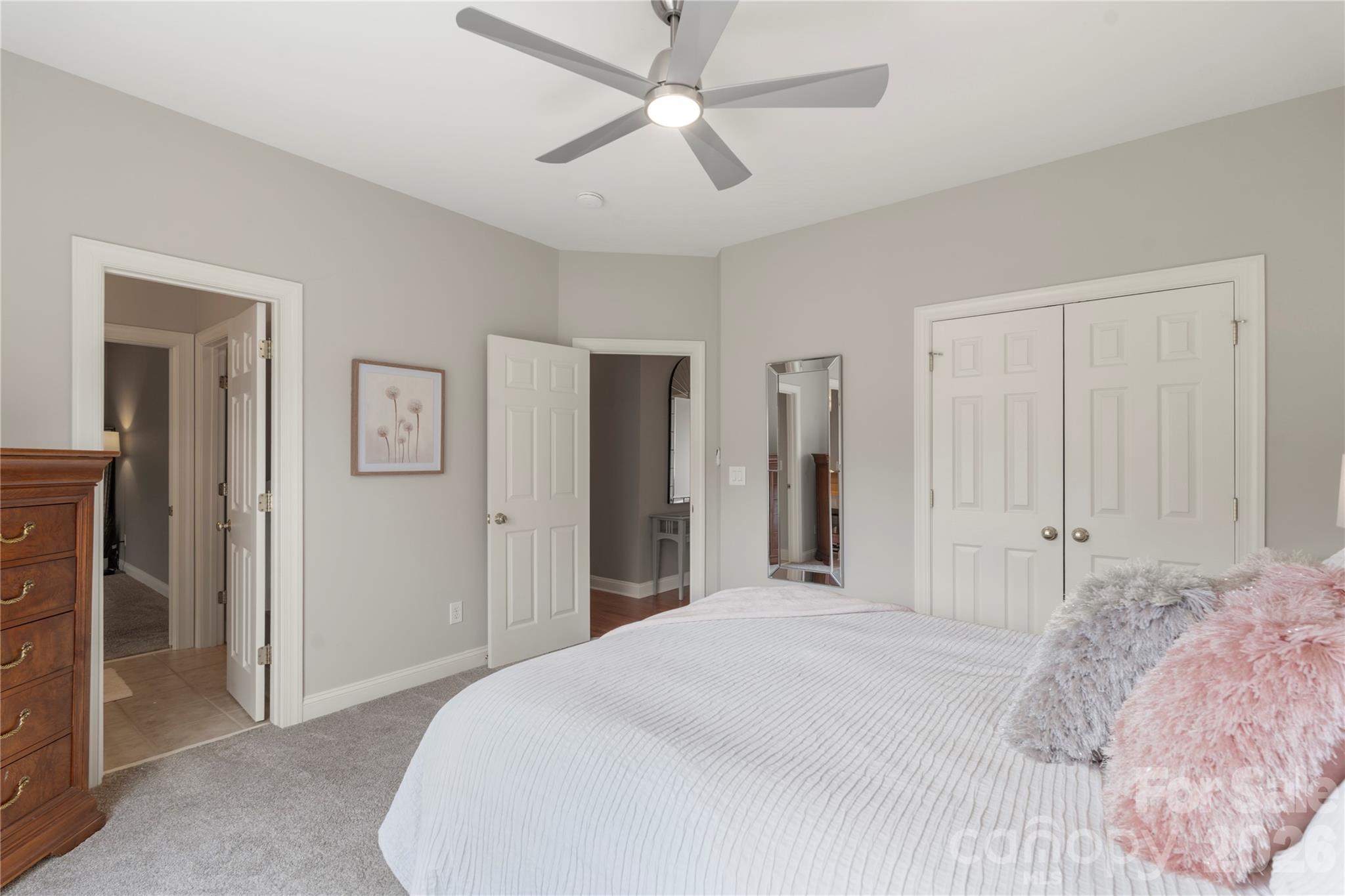 1716 Hickory Ridge Drive Waxhaw, NC 28173 - Photo 31 of 48 a bedroom with a bed and a chandelier