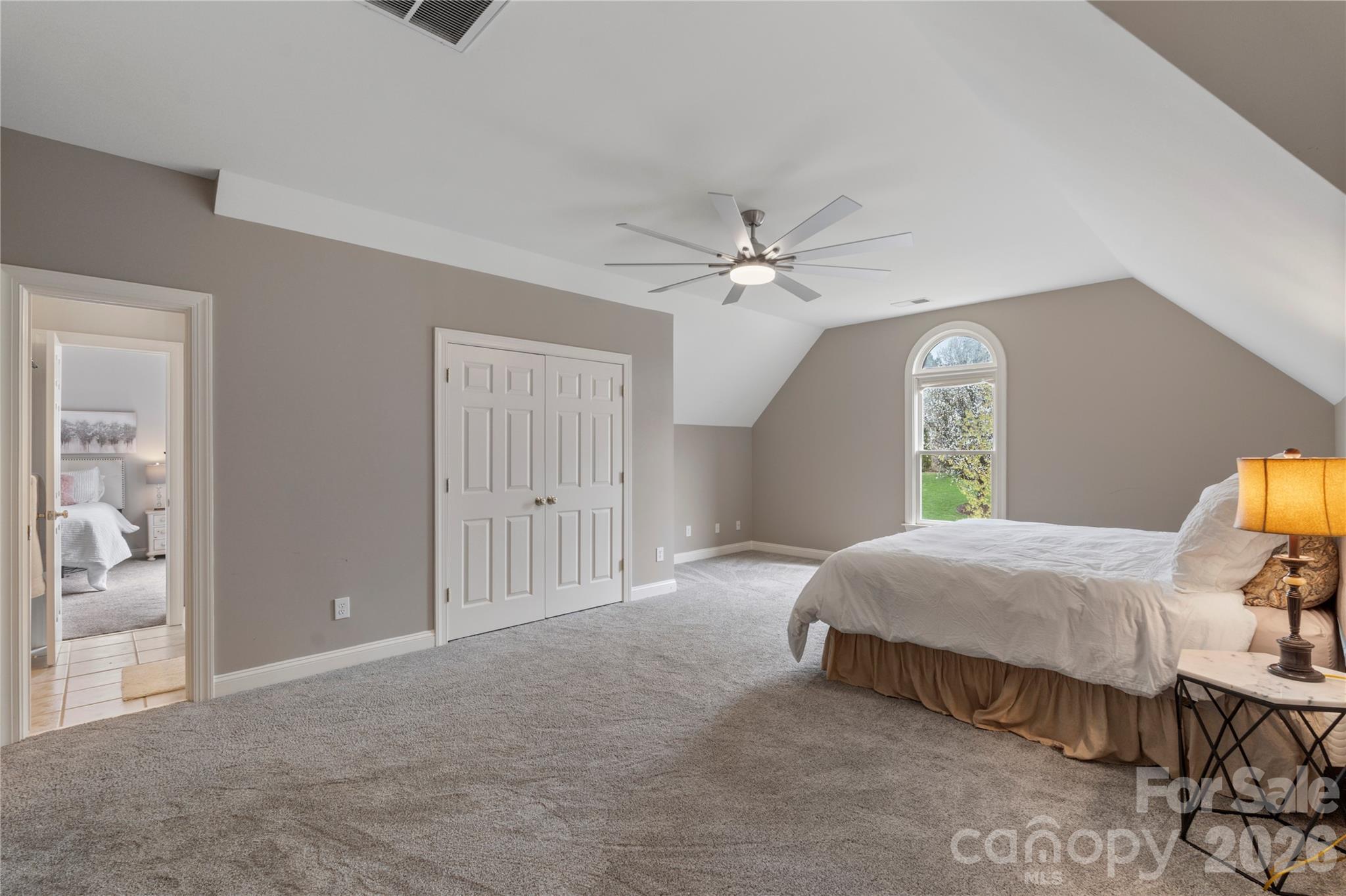 1716 Hickory Ridge Drive Waxhaw, NC 28173 - Photo 38 of 48 a spacious bedroom with a bed and a chandelier