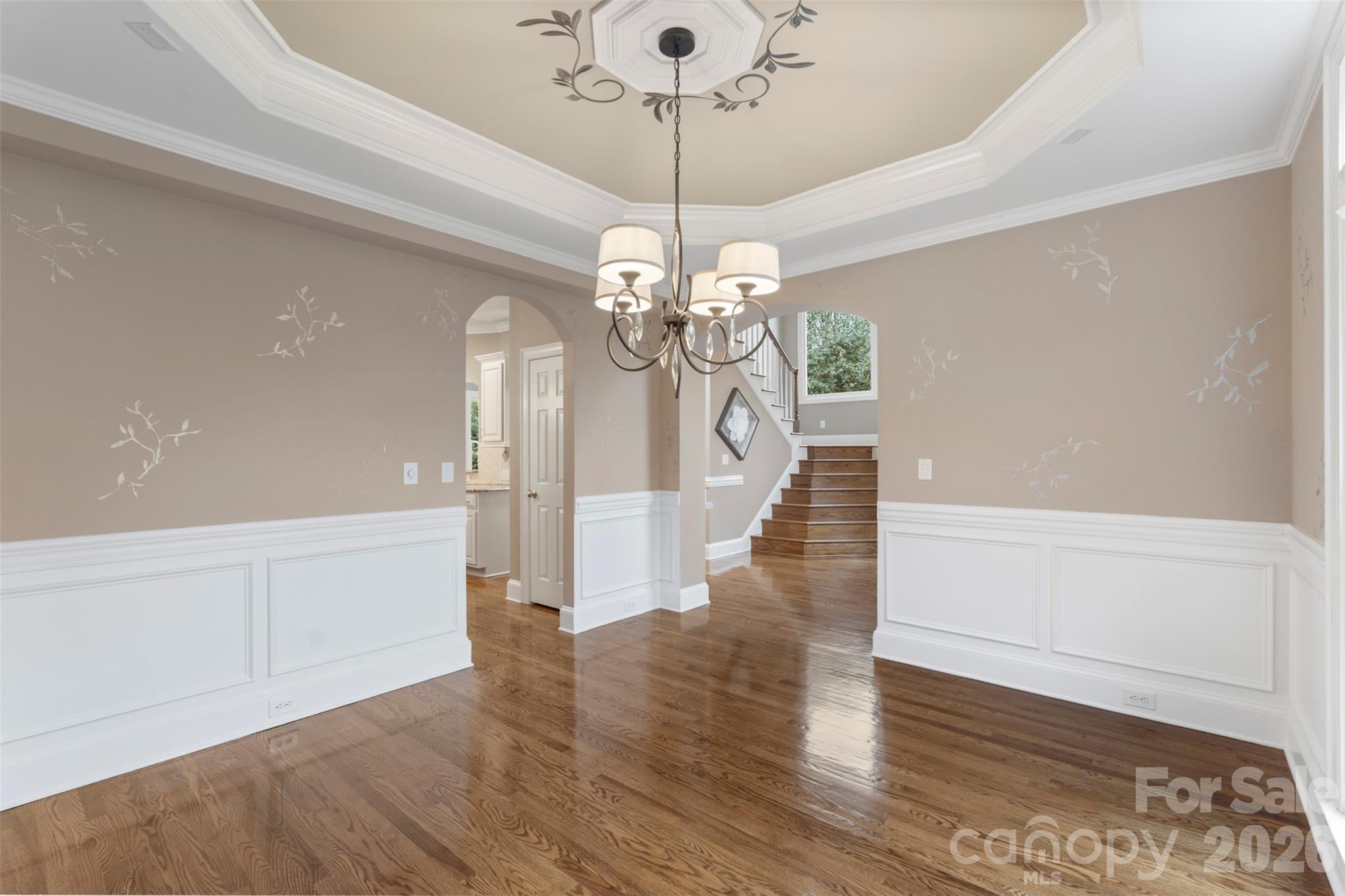 1716 Hickory Ridge Drive Waxhaw, NC 28173 - Photo 8 of 48 a view of a hallway with wooden floor and chandelier