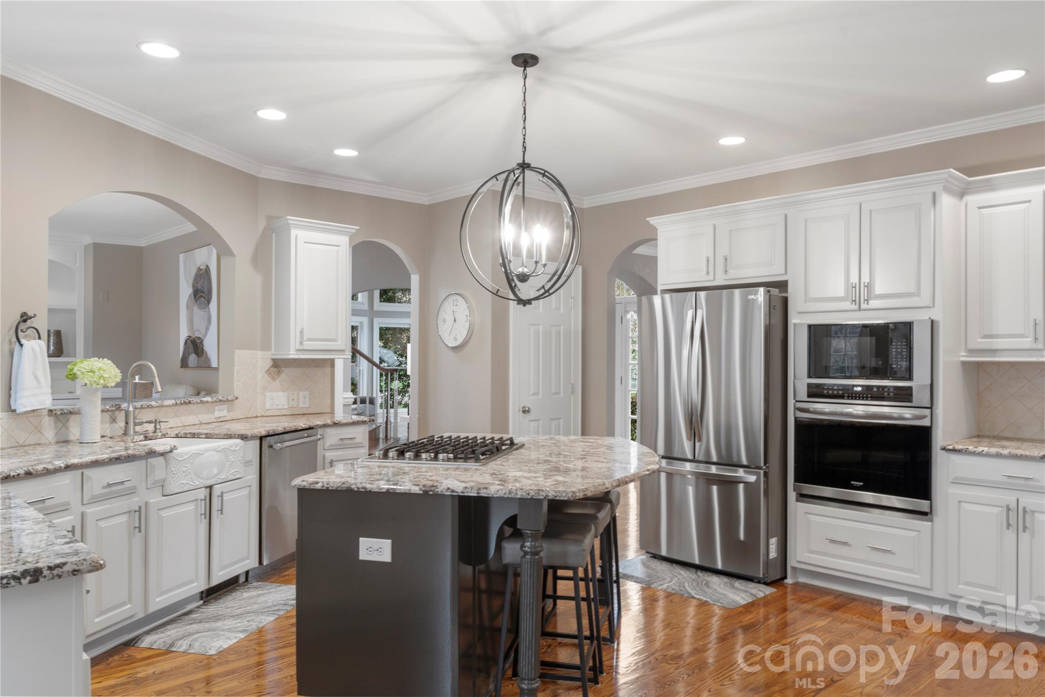 1716 Hickory Ridge Drive Waxhaw, NC 28173 - Photo 10 of 48 a kitchen with kitchen island granite countertop a sink cabinets and stainless steel appliances