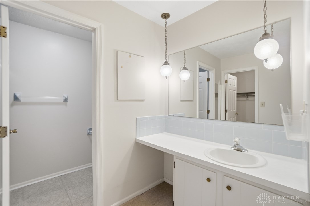 9964 Hummingbird Way Dayton, OH 45458 - Photo 32 of 57 This bathroom features a sleek vanity and convenient water closet, offering both style and functionality.
