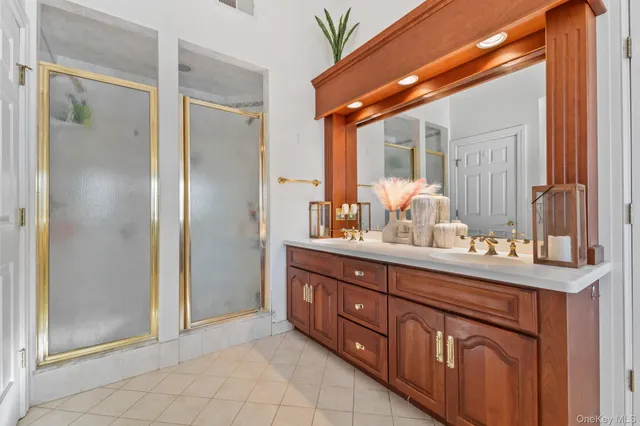 a bathroom with a double vanity sink and a mirror