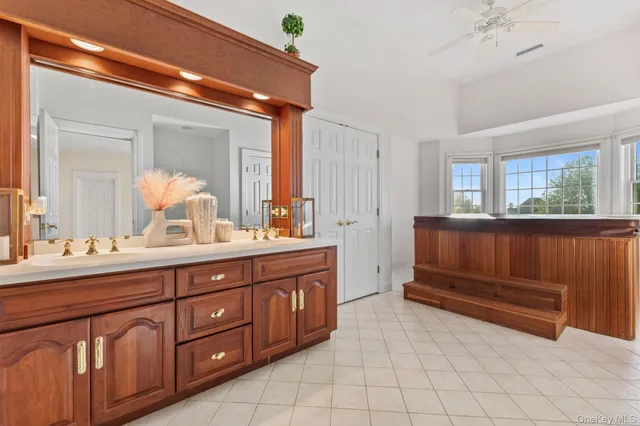 a spacious bathroom with a double vanity sink and a mirror