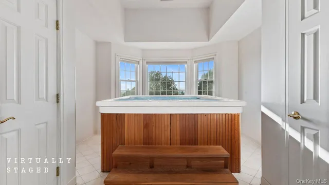 a view of balcony with a window and potted plants