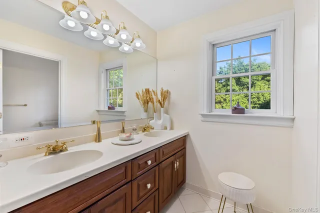 a bathroom with a sink a toilet and a mirror