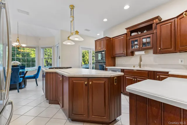a kitchen with stainless steel appliances granite countertop a sink stove and cabinets