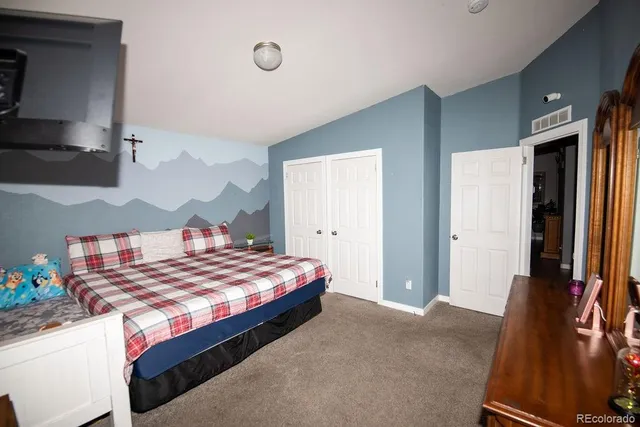 a spacious bathroom with a double vanity sink and a mirror