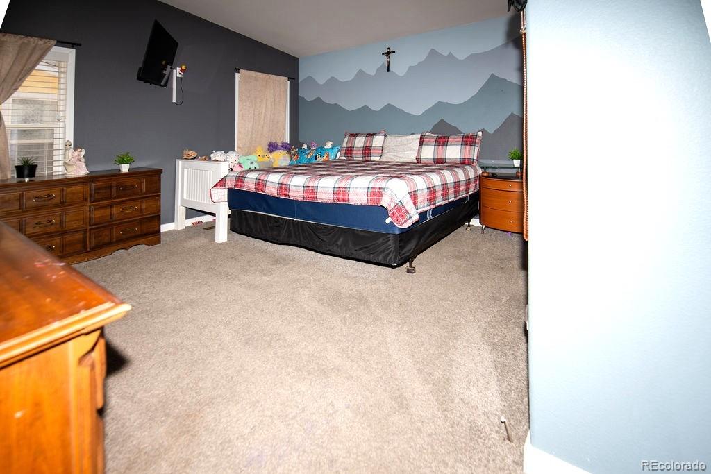 7725 Primrose Green, Unit 165 Frederick, CO 80530 - Photo 12 of 22 a bedroom with bed and window