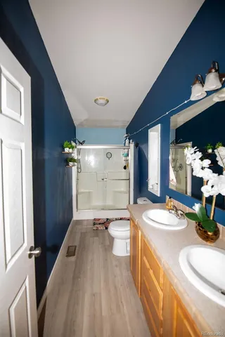 a bedroom with furniture and wooden floor