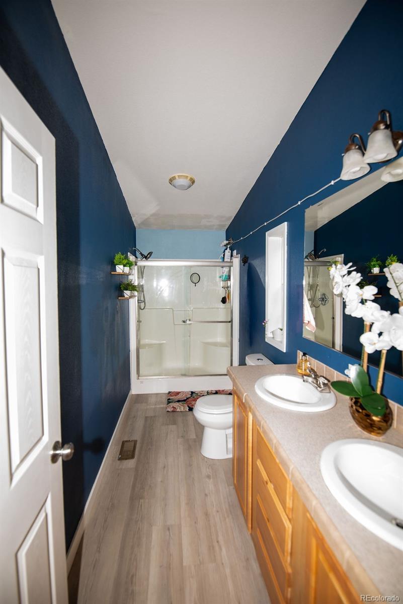 7725 Primrose Green, Unit 165 Frederick, CO 80530 - Photo 13 of 22 a spacious bathroom with a double vanity sink and a mirror
