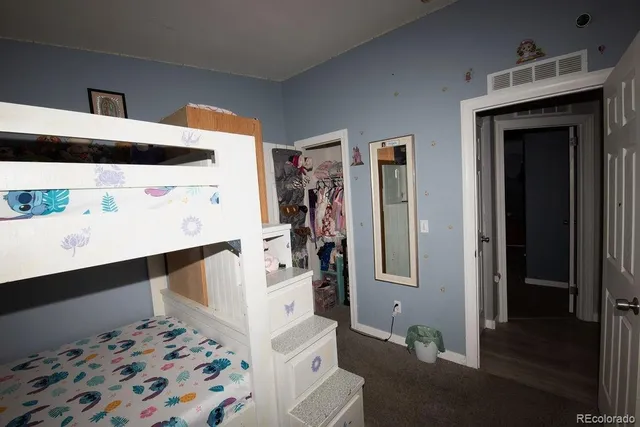 a view of a livingroom with wooden floor and cabinet