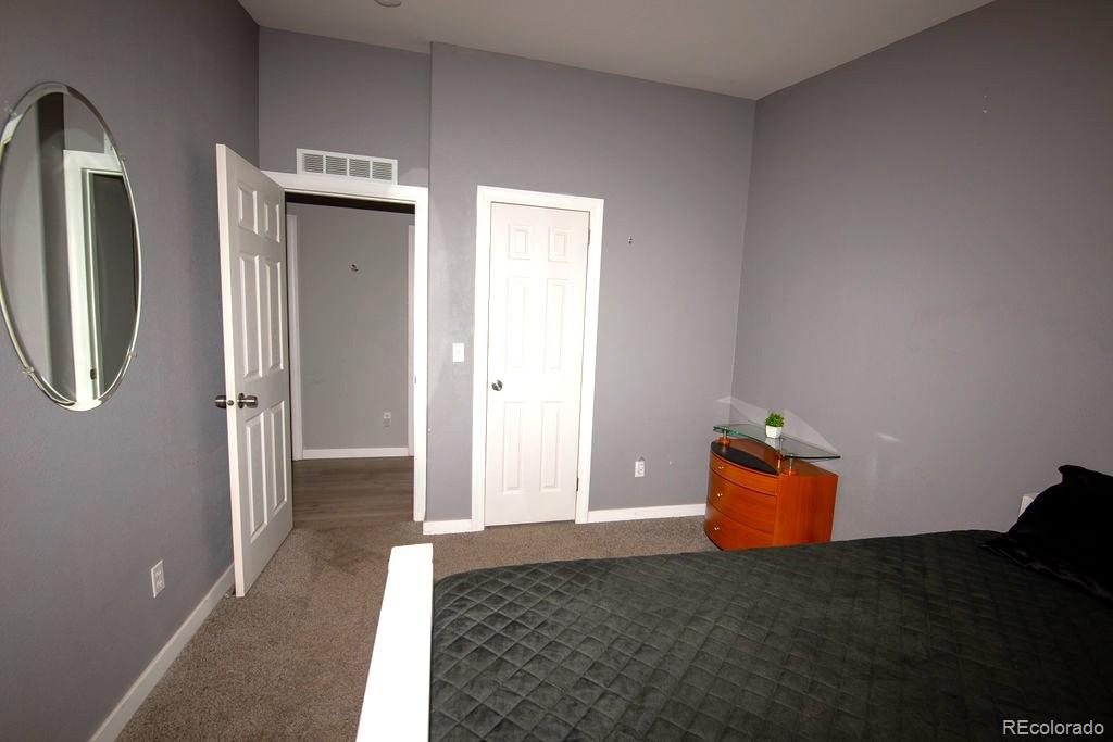 7725 Primrose Green, Unit 165 Frederick, CO 80530 - Photo 17 of 22 a view of a livingroom with wooden floor and cabinet