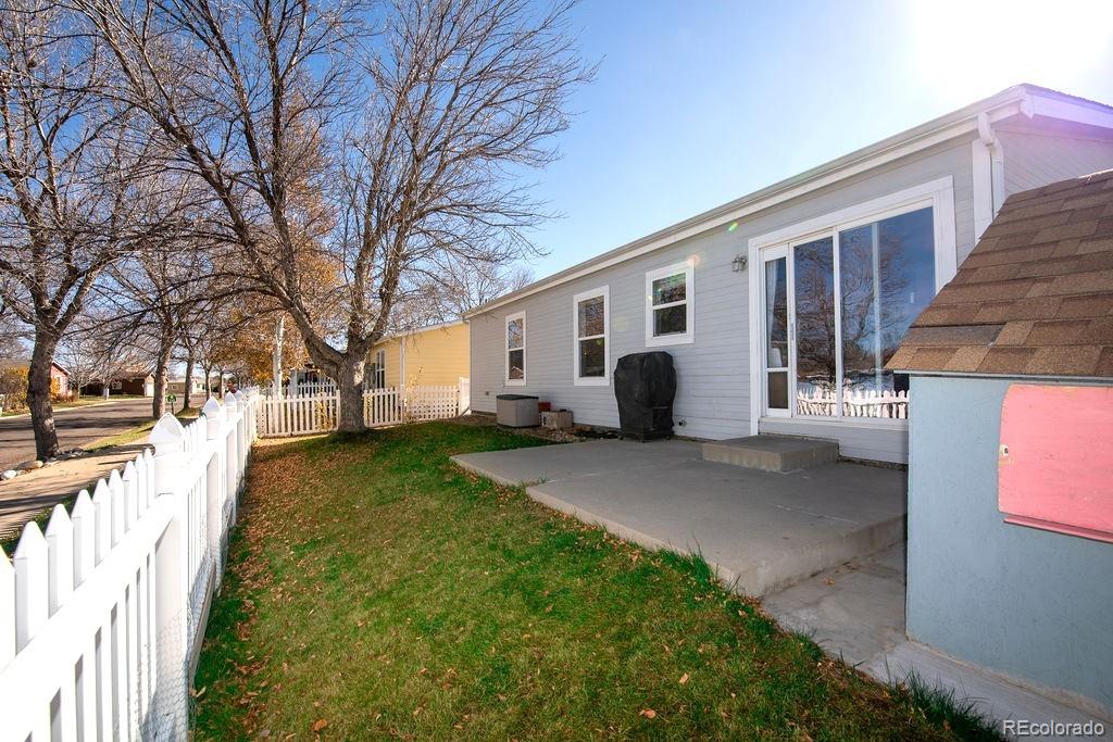 7725 Primrose Green, Unit 165 Frederick, CO 80530 - Photo 19 of 22 a view of a white house with a yard