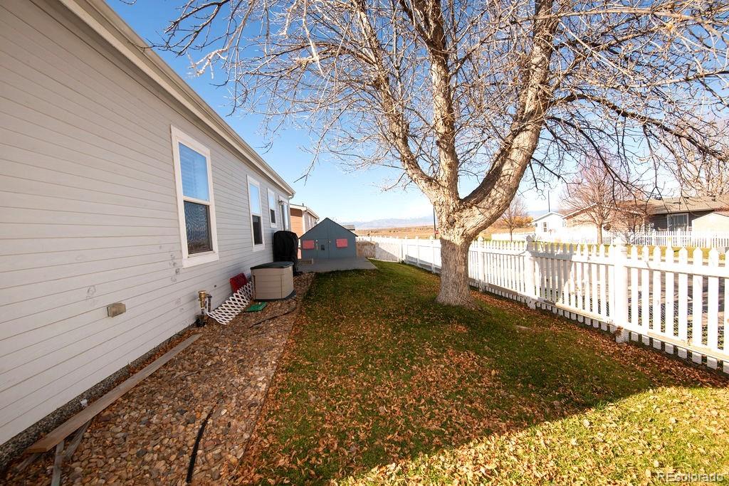 7725 Primrose Green, Unit 165 Frederick, CO 80530 - Photo 21 of 22 a backyard of a house with lots of green space