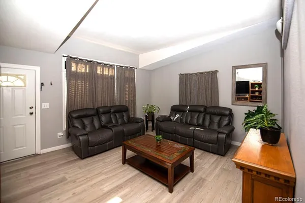 a living room with furniture and a potted plant