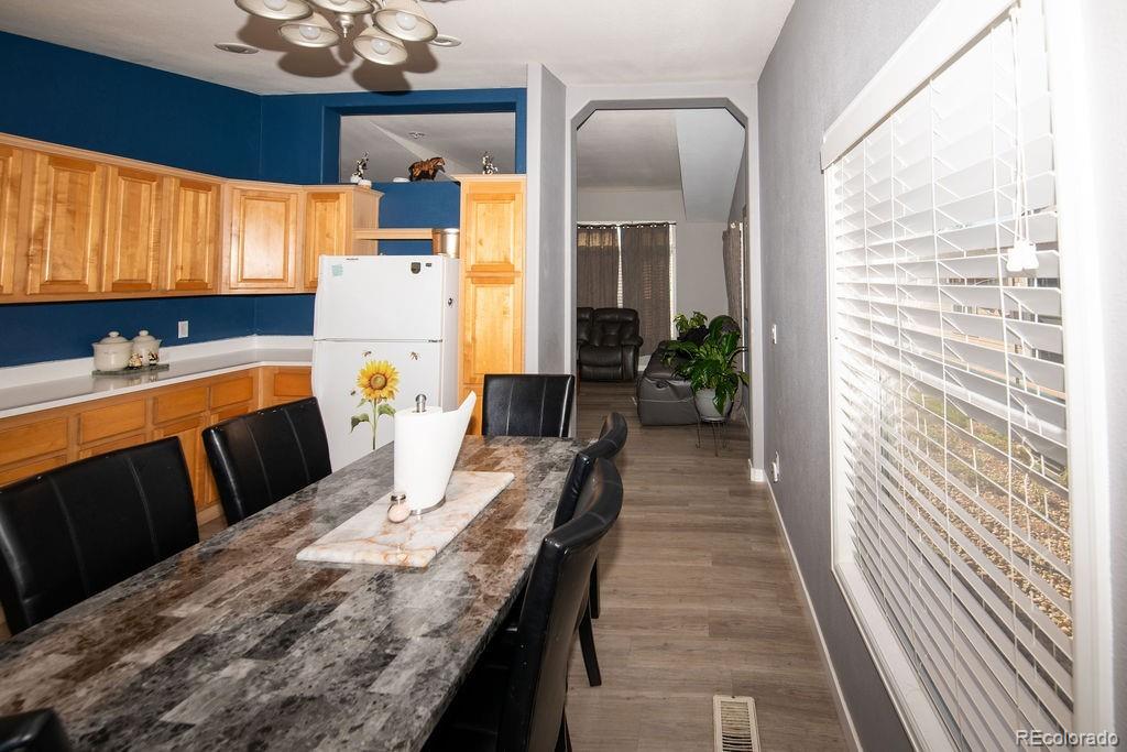 7725 Primrose Green, Unit 165 Frederick, CO 80530 - Photo 5 of 22 a dining room with furniture and a window