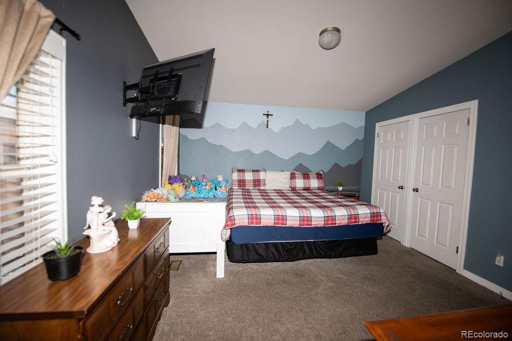 7725 Primrose Green, Unit 165 Frederick, CO 80530 - Photo 10 of 22 a bedroom with furniture and a window