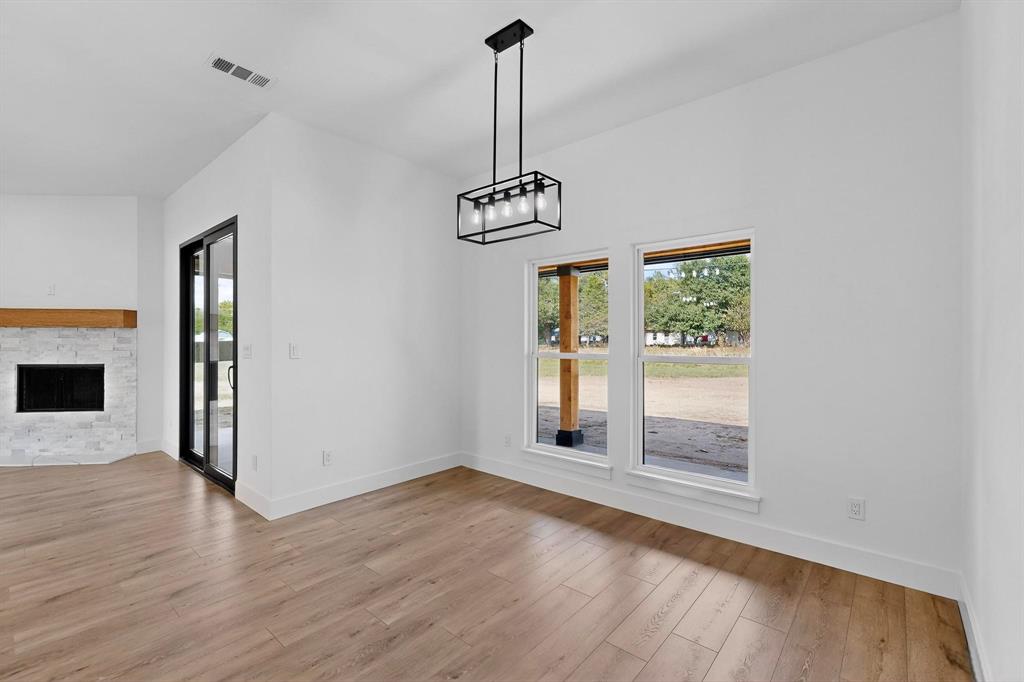 178 Private Road Canton, TX 75103 - Photo 13 of 38 a view of empty room with wooden floor and fan