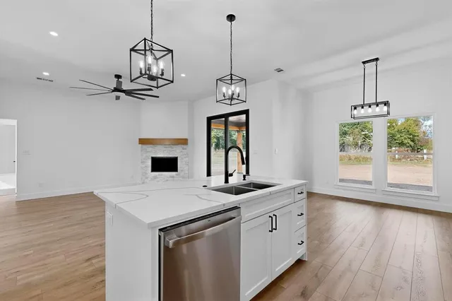 a view of a kitchen with a sink wooden floor and windows