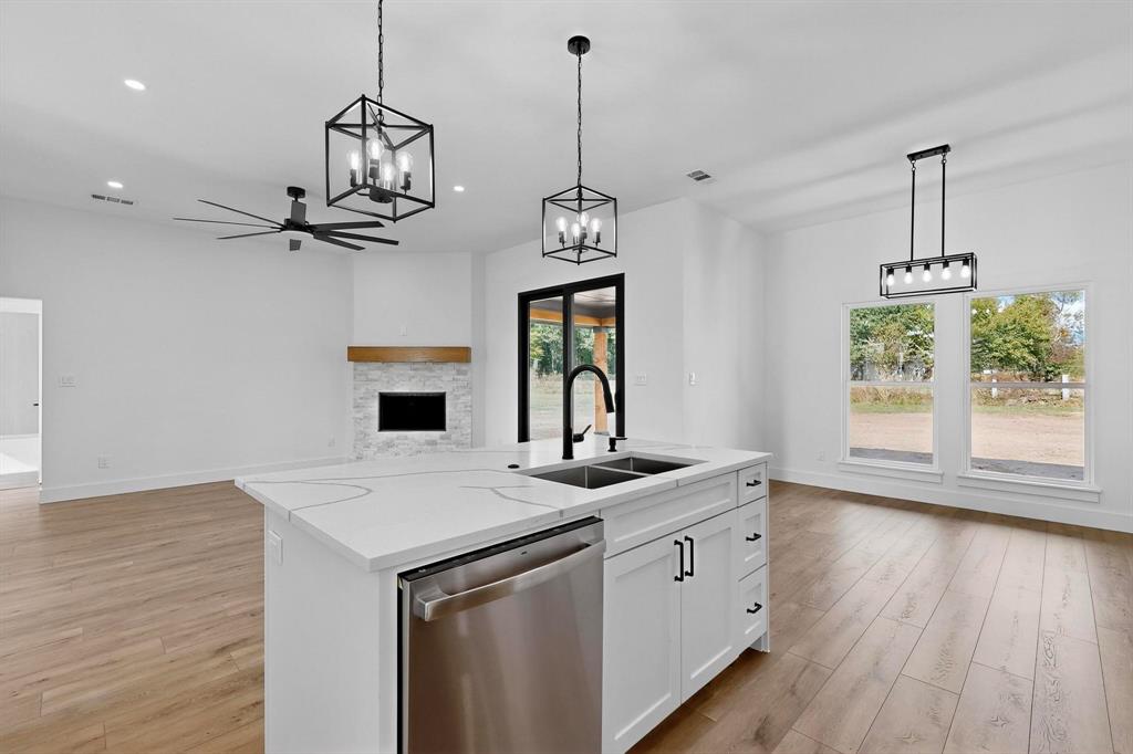 178 Private Road Canton, TX 75103 - Photo 14 of 38 a view of a kitchen with a sink wooden floor and windows