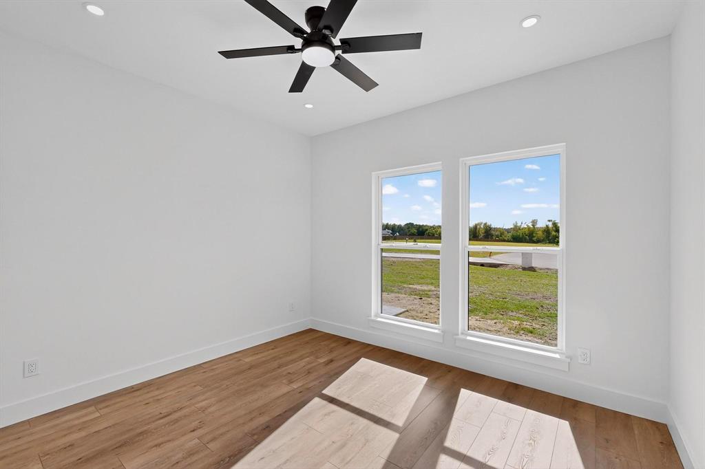 178 Private Road Canton, TX 75103 - Photo 22 of 38 wooden floor in an empty room with a window