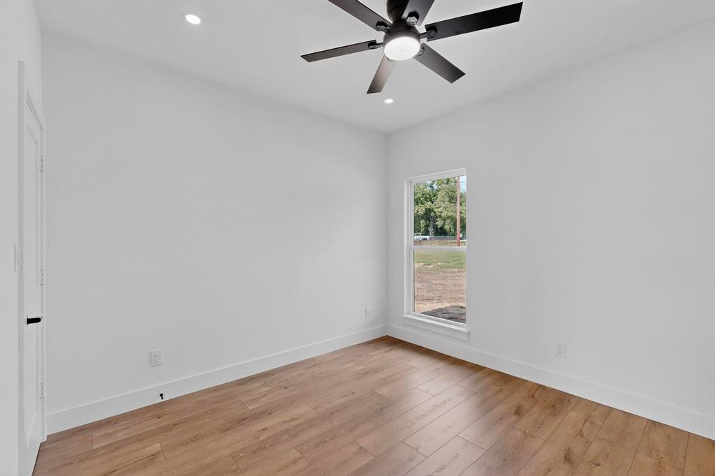 178 Private Road Canton, TX 75103 - Photo 26 of 38 wooden floor in an empty room with a window
