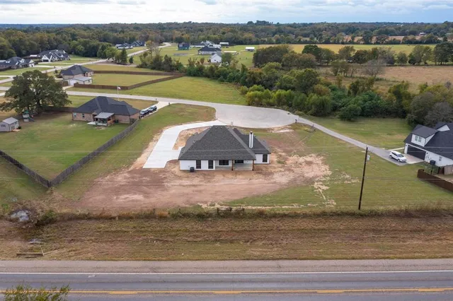 an aerial view of a house with a yard basket ball court and outdoor seating