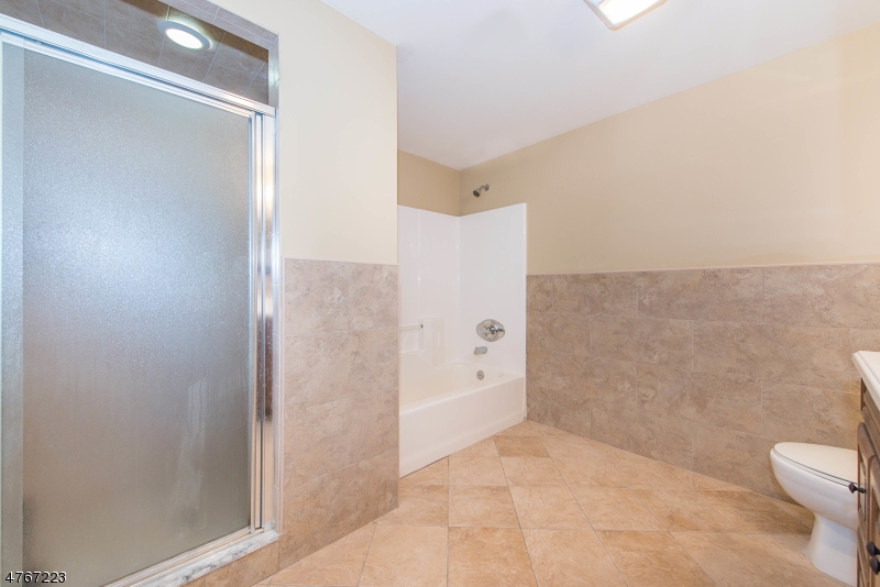 1677 Springfield Avenue, Unit 14 Maplewood, NJ 07040 - Photo 11 of 13 a bathroom with a shower and a toilet