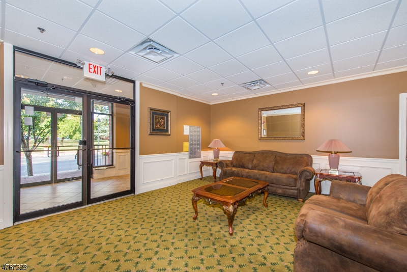 1677 Springfield Avenue, Unit 14 Maplewood, NJ 07040 - Photo 2 of 13 a living room with furniture a flat screen tv and a table